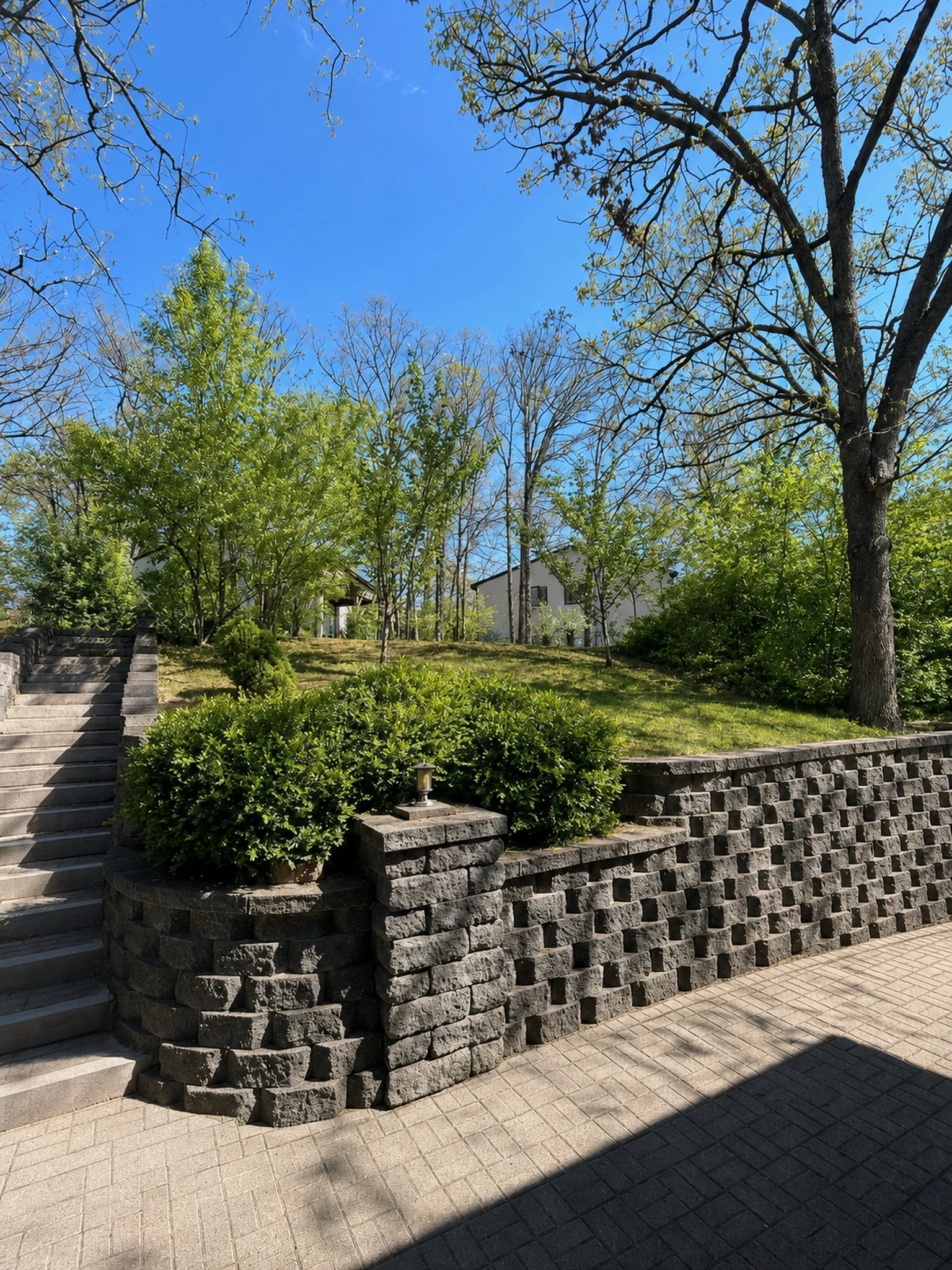 Stone stairs, landscaped shrubs, and retaining wall on the Morningside Village grounds