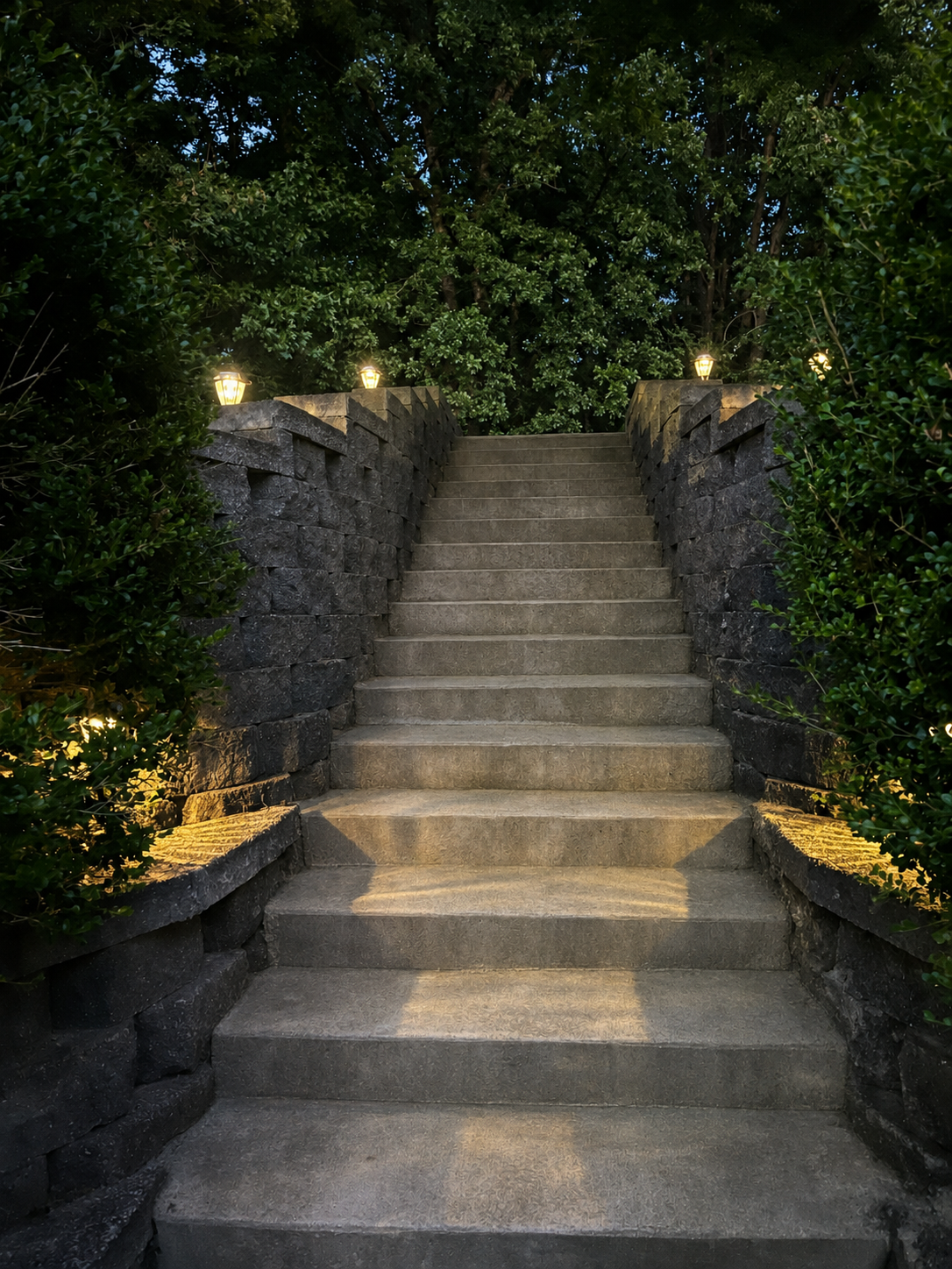 Stone retaining wall surrounding stairs leading up to the Morningside Village parking lot