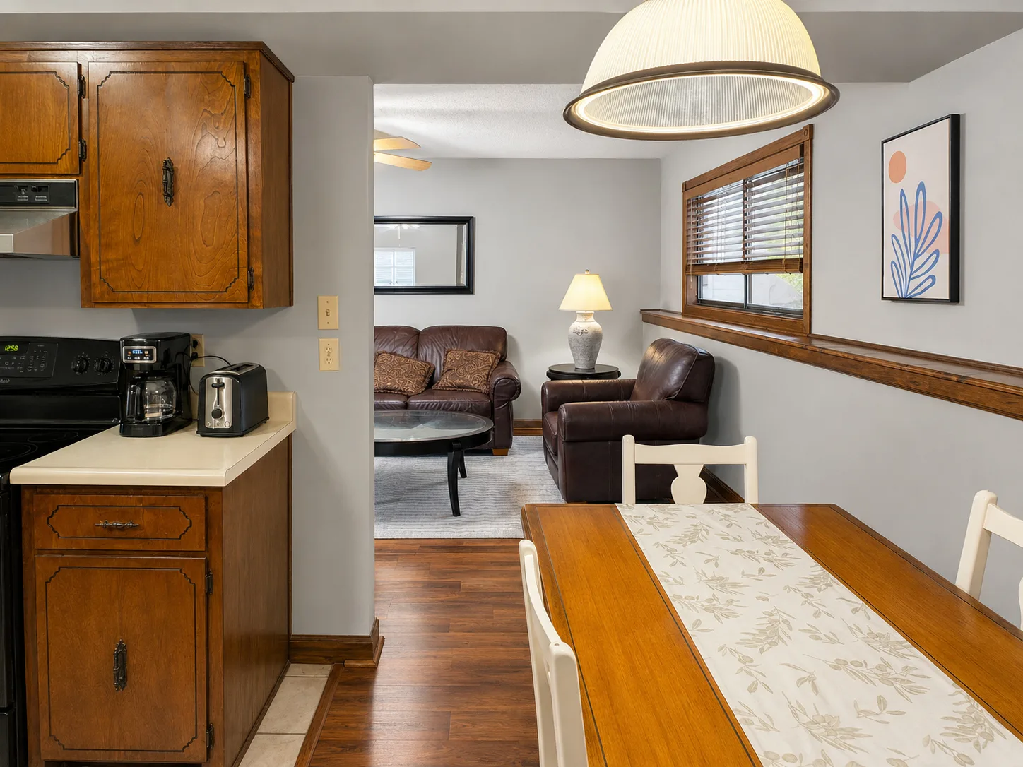 Dining room opening into the furnished living room in apartment 1301 B