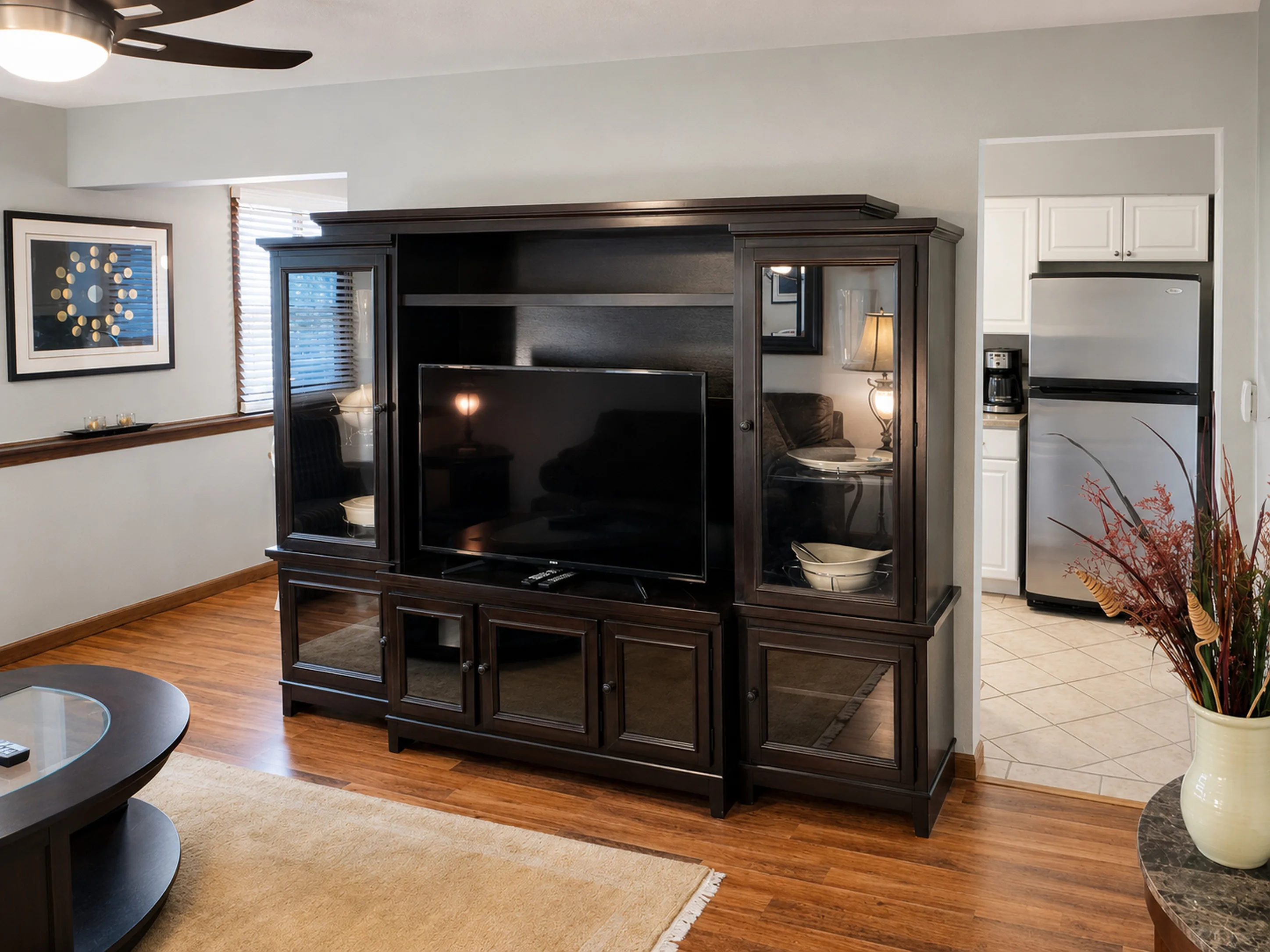 Entertainment center opening toward the kitchen in apartment 1307 B