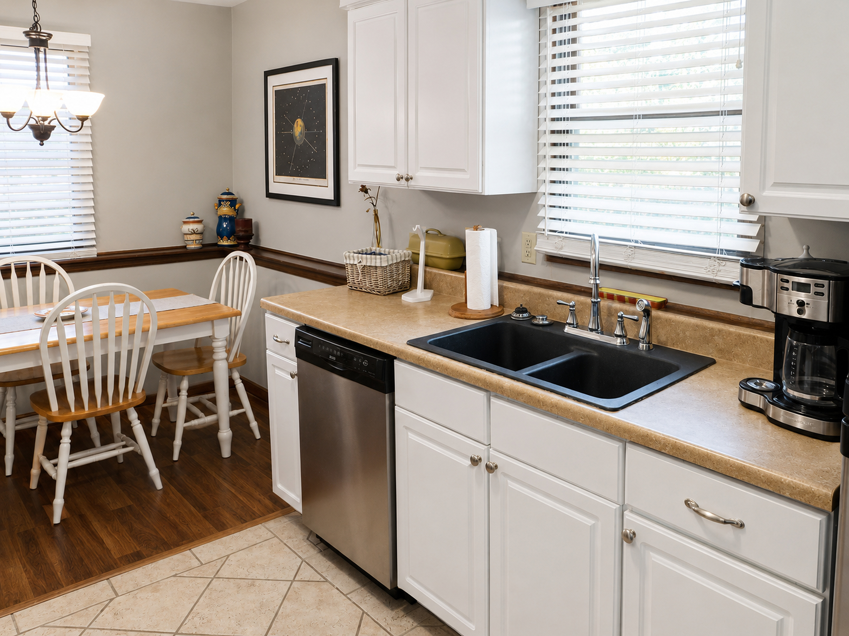 Kitchen sink, cabinetry, and dining area in apartment 1307 B