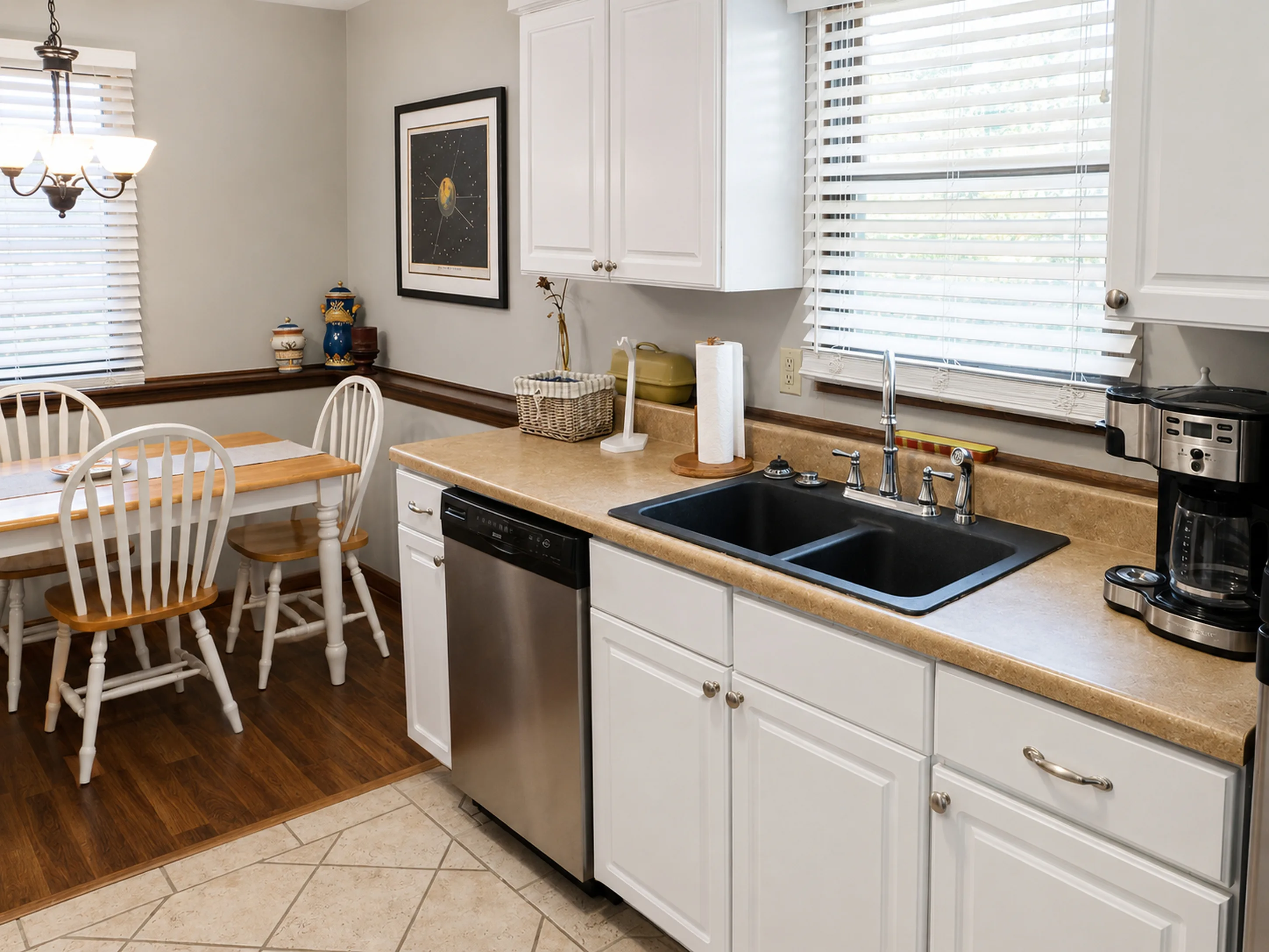 Kitchen sink, cabinetry, and dining area in apartment 1307 B