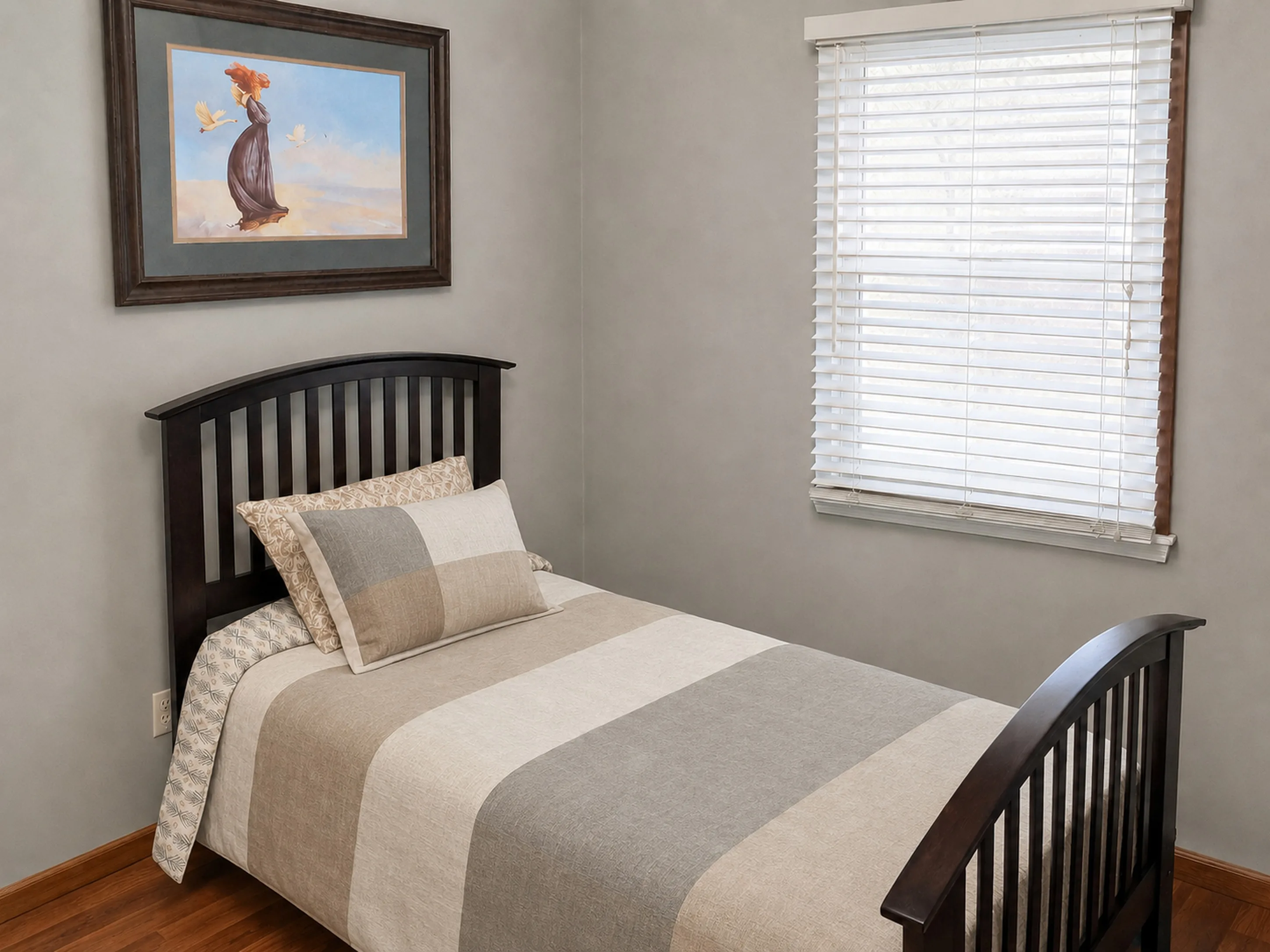 Furnished second bedroom in apartment 1307 B with a modern neutral comforter