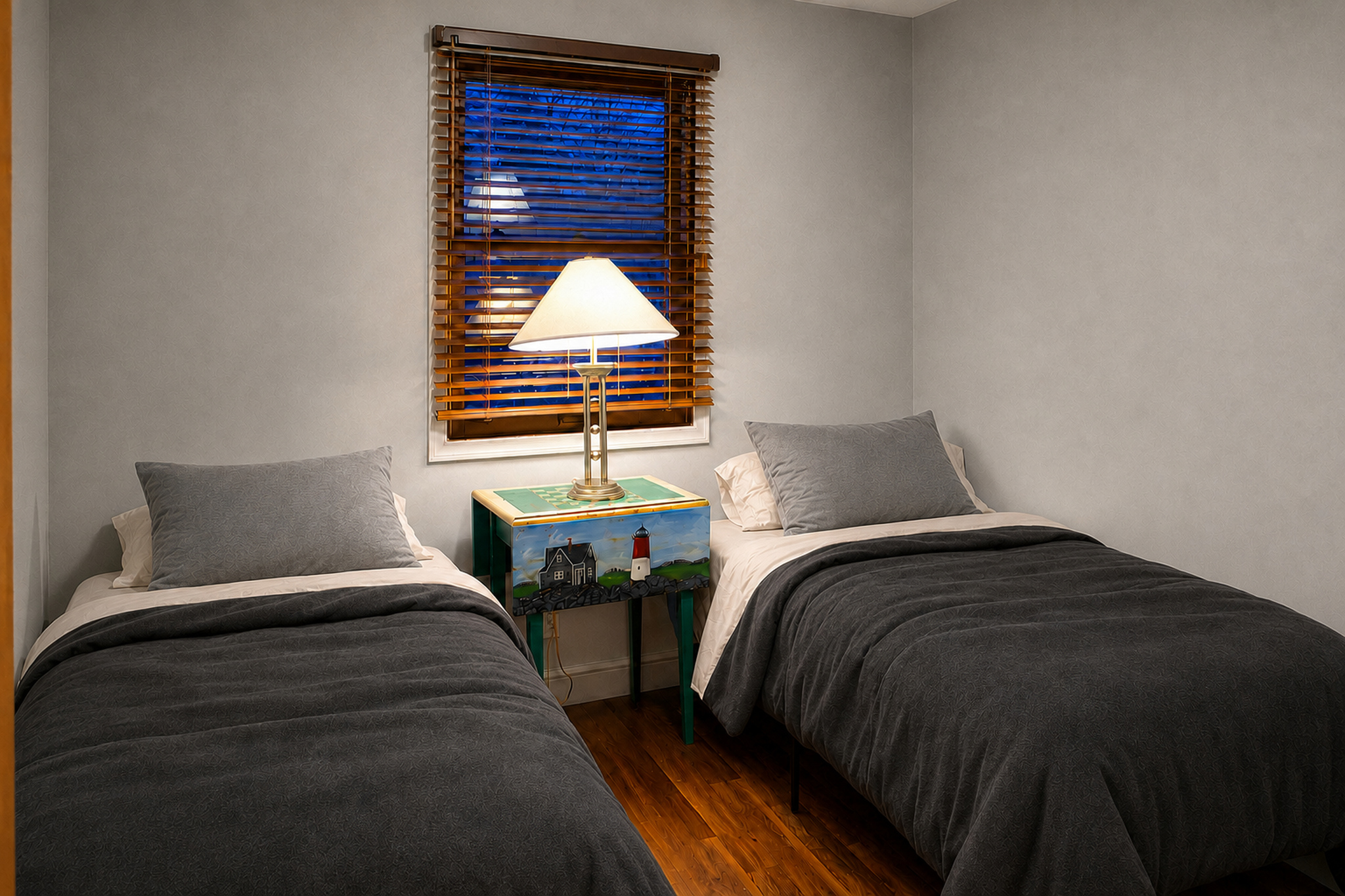 Twin bedroom in furnished apartment 2008 D with charcoal flannel bedding and off-white sheets