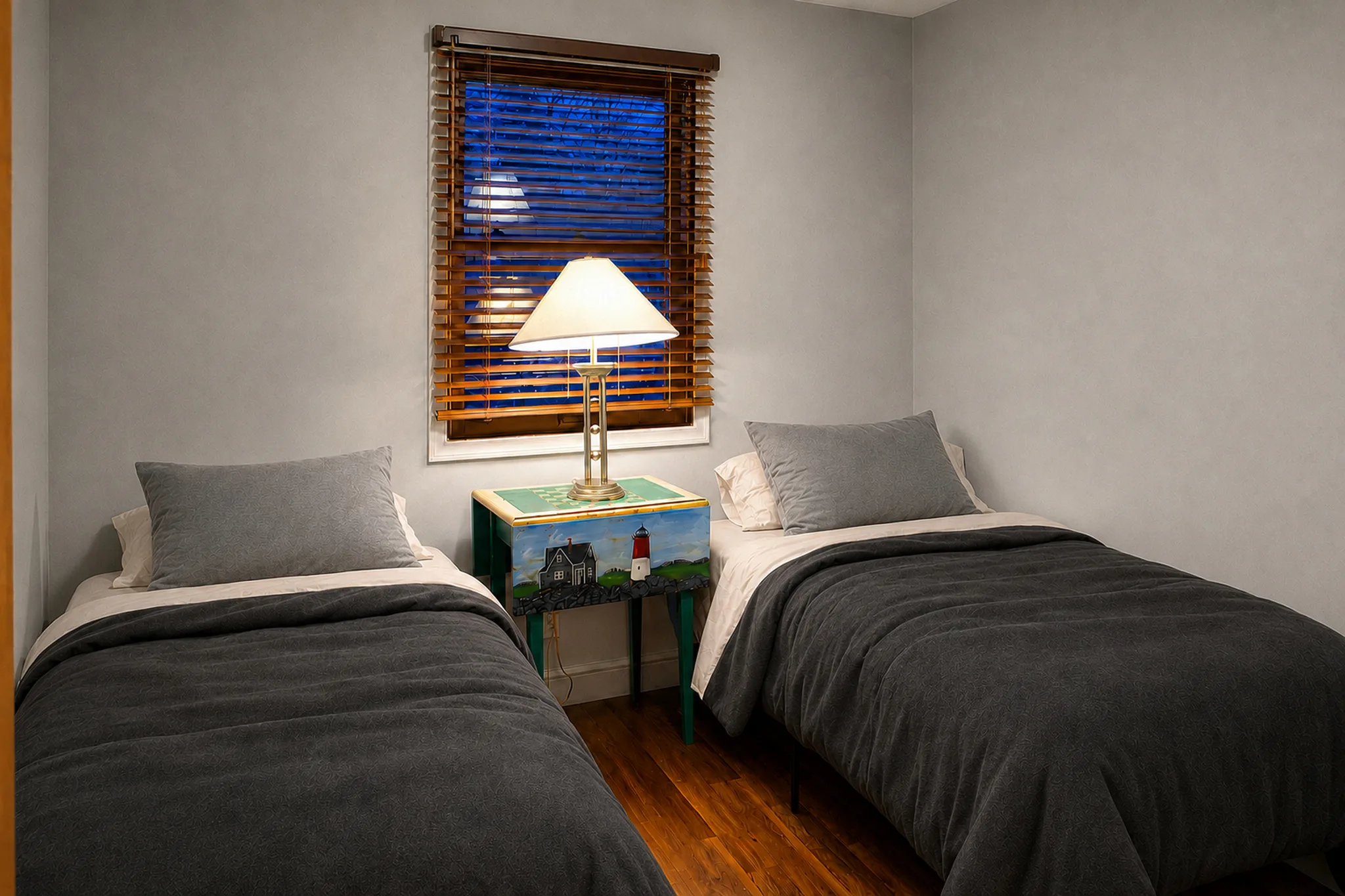 Twin bedroom in furnished apartment 2008 D with charcoal flannel bedding and off-white sheets